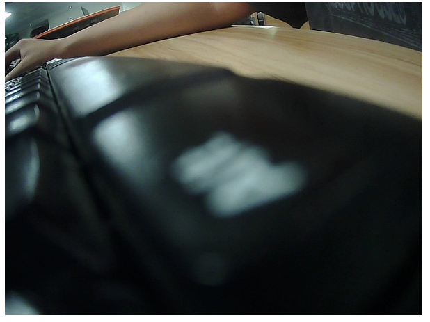 camera showing a keyboard with a student's hand